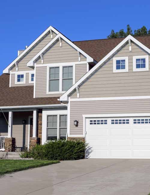 Tan home from front lawn