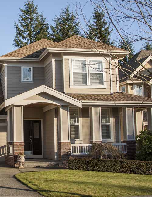 Tan siding at dawn/dusk of a home