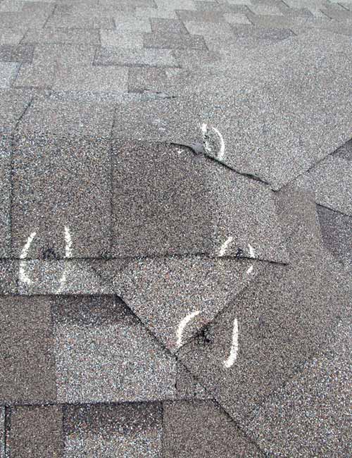 Hail damaged shingles marked with chalk